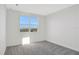 Bright bedroom with grey carpet and a window at 9144 Gulf Haven Dr, Parrish, FL 34219