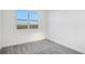 Spacious bedroom with gray carpet and a window overlooking the neighborhood at 9144 Gulf Haven Dr, Parrish, FL 34219