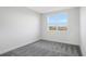 Well-lit bedroom with gray carpet and a large window at 9144 Gulf Haven Dr, Parrish, FL 34219