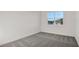 Simple bedroom with grey carpet and window at 9144 Gulf Haven Dr, Parrish, FL 34219