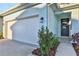 Front view of townhome with two-car garage and landscaping at 9144 Gulf Haven Dr, Parrish, FL 34219