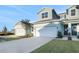 Two-story townhome with light blue exterior, two-car garage, and landscaping at 9144 Gulf Haven Dr, Parrish, FL 34219