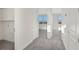 Clean and bright hallway with grey carpet and doors at 9144 Gulf Haven Dr, Parrish, FL 34219