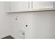 Bright laundry room with white cabinets and gray tile floor at 9144 Gulf Haven Dr, Parrish, FL 34219