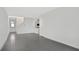 Open living area with grey tile floors and access to the front door at 9144 Gulf Haven Dr, Parrish, FL 34219