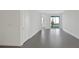 Open living area with grey tile floors and access to backyard patio at 9144 Gulf Haven Dr, Parrish, FL 34219