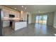Modern kitchen with white cabinets, island, and gray tile floors at 9222 Gulf Haven Dr, Parrish, FL 34219