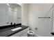 Modern bathroom with dark vanity and a large mirror at 9222 Gulf Haven Dr, Parrish, FL 34219