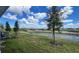 View of backyard with canal, grass and trees at 9222 Gulf Haven Dr, Parrish, FL 34219