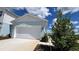 Two-car garage with white doors and light blue exterior at 9222 Gulf Haven Dr, Parrish, FL 34219