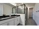 Modern bathroom with double vanity, dark countertop and walk-in shower at 9222 Gulf Haven Dr, Parrish, FL 34219