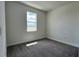 Spacious bedroom with gray carpeting and large window at 9222 Gulf Haven Dr, Parrish, FL 34219