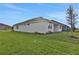 House exterior showcasing a well-maintained lawn and a covered patio at 7474 Sea Manatee St, Parrish, FL 34219