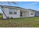 Covered patio and grassy backyard with access from the home at 7474 Sea Manatee St, Parrish, FL 34219