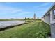 Backyard with pond view, grassy lawn, and covered patio at 7474 Sea Manatee St, Parrish, FL 34219