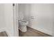 Small bathroom with toilet and wood-look tile floor at 7474 Sea Manatee St, Parrish, FL 34219