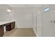Modern bathroom with double vanity, dark brown cabinets, and a glass shower at 7474 Sea Manatee St, Parrish, FL 34219