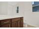 Modern bathroom with dark brown vanity, white toilet, and a large mirror at 7474 Sea Manatee St, Parrish, FL 34219