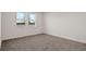 Spacious bedroom with neutral carpeting and lake views at 7474 Sea Manatee St, Parrish, FL 34219