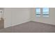Bright bedroom with carpet flooring and large windows offering a water view at 7474 Sea Manatee St, Parrish, FL 34219