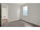 Well-lit bedroom featuring wood-look floors and an open door to another room at 7474 Sea Manatee St, Parrish, FL 34219