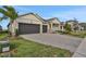 Two-story house with a three-car garage and a nicely landscaped front yard at 7474 Sea Manatee St, Parrish, FL 34219