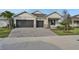 Two-story house with two-car garage, paver driveway, and landscaped front yard at 7474 Sea Manatee St, Parrish, FL 34219