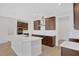 Kitchen island with white countertop and stainless steel sink, dark wood cabinets at 7474 Sea Manatee St, Parrish, FL 34219