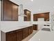 Modern kitchen with dark wood cabinets and white countertops at 7474 Sea Manatee St, Parrish, FL 34219