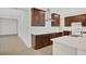 Modern kitchen with dark wood cabinets and white countertops at 7474 Sea Manatee St, Parrish, FL 34219