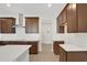 Modern kitchen with dark wood cabinets, white countertops, and stainless steel appliances at 7474 Sea Manatee St, Parrish, FL 34219