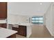 Kitchen with island, stainless steel sink, and views into the living room at 7474 Sea Manatee St, Parrish, FL 34219