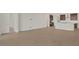 Open living room with tile floor and view into kitchen with island at 7474 Sea Manatee St, Parrish, FL 34219