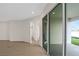 Living area with tile floors, sliding glass doors to patio and lake view at 7474 Sea Manatee St, Parrish, FL 34219