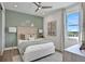 Bedroom with light green accent wall, queen bed and window seat at 7478 Sea Manatee St, Parrish, FL 34219