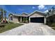 New construction home exterior featuring a 2-car garage and landscaping at 7490 Sea Manatee St, Parrish, FL 34219