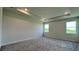 Spacious bedroom with plush carpeting and large windows offering natural light at 7490 Sea Manatee St, Parrish, FL 34219