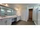 Elegant bathroom with double vanity, large mirror, and walk-in shower at 7490 Sea Manatee St, Parrish, FL 34219