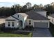 Two story home with gray roof, light gray siding, and gray garage door at 7465 Sea Manatee St, Parrish, FL 34219