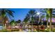 Evening view of a charming town square with fountains and palm trees at 9039 Duany Ln, Lakewood Ranch, FL 34240