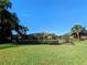 Private backyard with lush lawn, landscaping, and a fenced perimeter at 917 Riverscape St, Bradenton, FL 34208