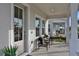 Inviting front porch with seating, offering a welcoming entrance to this stylish home at 168 Eagleston Ln, Lakewood Ranch, FL 34240