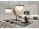 Well-lit kitchen with stainless appliances, an island with seating, and stylish pendant lights at 168 Eagleston Ln, Lakewood Ranch, FL 34240