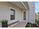 Inviting side entrance with a cozy bench and a well-maintained exterior at 168 Eagleston Ln, Lakewood Ranch, FL 34240