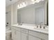 Bathroom featuring double sinks, a large mirror, and a shower-tub combination at 9031 Duany Ln, Lakewood Ranch, FL 34240