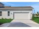 Garage featuring a modern style door, concrete driveway, and a manicured lawn at 9031 Duany Ln, Lakewood Ranch, FL 34240
