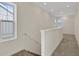 Bright hallway featuring neutral walls, carpet flooring, and staircase to the left at 9031 Duany Ln, Lakewood Ranch, FL 34240