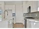 Bright kitchen features stainless steel appliances, ample storage, and stylish backsplash at 9031 Duany Ln, Lakewood Ranch, FL 34240
