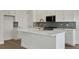 Close-up of the kitchen island featuring a white countertop and a designer faucet at 9031 Duany Ln, Lakewood Ranch, FL 34240