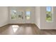 Bright and airy living room with beautiful hardwood flooring and natural light at 9031 Duany Ln, Lakewood Ranch, FL 34240